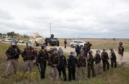 Police form a line during protests against the Dakota Access Pipeline between the Standing Rock Reservation and the pipeline route outside the little town of Saint Anthony, North Dakota, U.S., October 5, 2016. REUTERS/Terray Sylvester