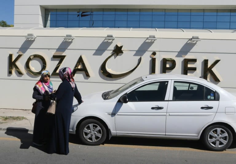 Women outside the Koza Ipek Holding building in Ankara on September 1, 2015, as Turkish police officers raid the media group's offices