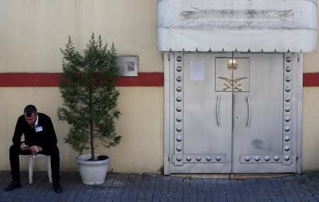 FILE PHOTO: A member of security staff sits at the entrance of Saudi Arabia's consulate in Istanbul