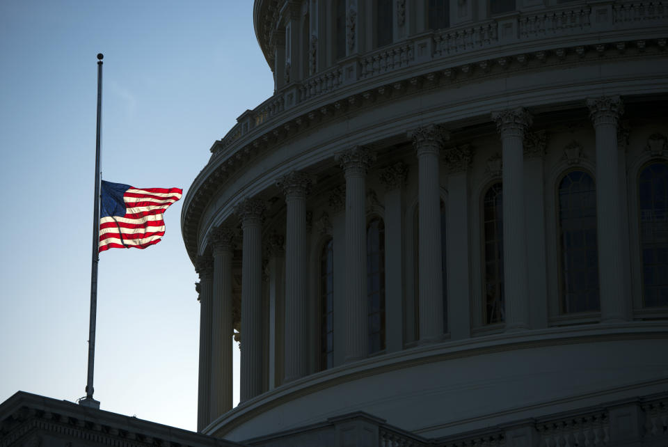 A flag flies at half-staff over the U.S. Capitol.