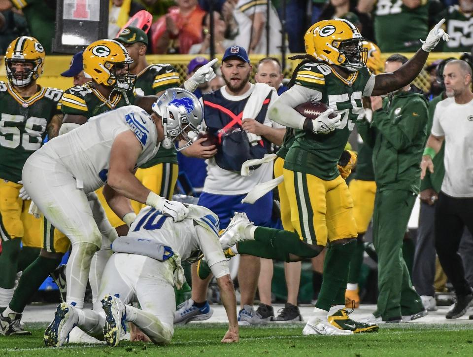 Packers linebacker De'Vondre Campbell celebrates after intercepting a pass from Lions quarterback Jared Goff, middle, in the fourth quarter of the Lions' 35-17 loss on Monday, Sept. 20, 2021, in Green Bay, Wisconsin.