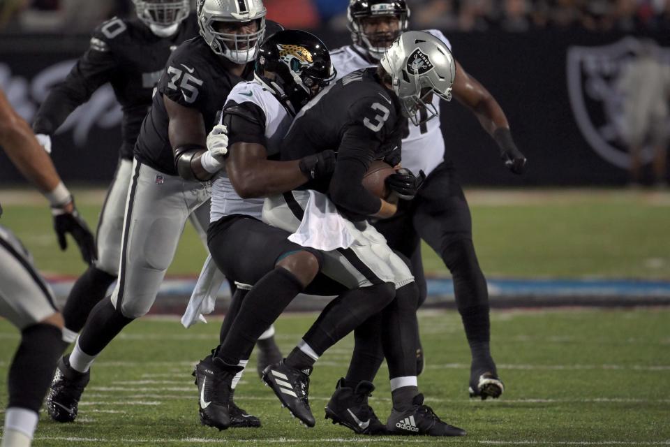 Jaguars rookie outside linebacker Travon Walker sacks Raiders quarterback Jared Stidham on Aug. 4 during the Pro Football Hall of Fame game in Canton, Ohio.