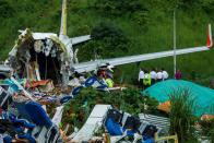 Officials inspect the wreckage of an Air India Express jet at Calicut International Airport in Karipur, Kerala, on August 8, 2020. - Fierce rain and winds lashed a plane carrying 190 people before it crash-landed and tore in two at an airport in southern India, killing at least 18 people and injuring scores more, officials said on August 8. (Photo by Arunchandra BOSE / AFP) (Photo by ARUNCHANDRA BOSE/AFP via Getty Images)