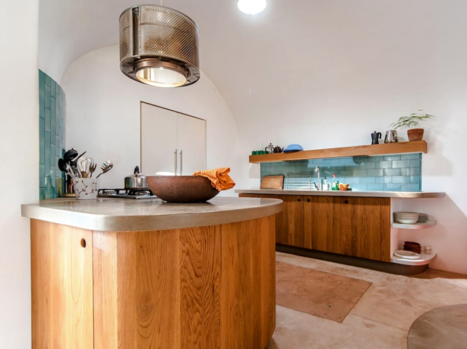 <p>The open-concept main room has an ultra-modern kitchen with polished concrete counters. (Airbnb) </p>