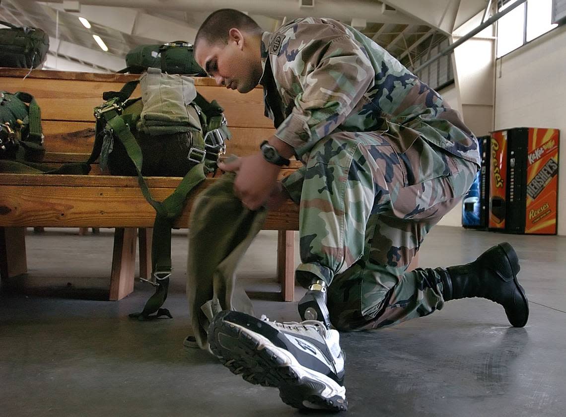 82nd Airborne Spec George Perez readies his gear before he boards an Air Force C-130 at the Green Ramp at Pope Air Force Base Saturday March 19,2005. The sneaker is attached to the prosthetic leg Perez has. Perez lost his leg in Fallujah,Iraq when a roadside bomb destroyed the vehicle he was riding in. Perez was making the jump so he could qualify to go to Afghanistan with the 82nd Airborne later this year. After his first jump a little over a month ago Perez’s prosthesis was destroyed when he made a hard landing. STAFF PHOTO:CHUCK LIDDY