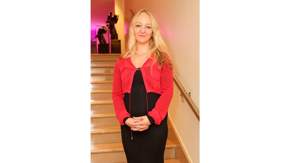 Claire Ptak in a red top and black dress