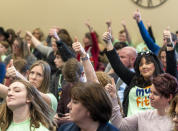 People give a thumbs up as they agree with one of the speakers during the Senate Education Committee public comments about HB215, on Monday, Jan. 23, 2023, in Salt Lake City. Several years of pandemic restrictions and curriculum battles have emboldened longtime advocates of funneling public funds to private and religious schools in statehouses throughout the country. (Rick Egan/The Salt Lake Tribune via AP)