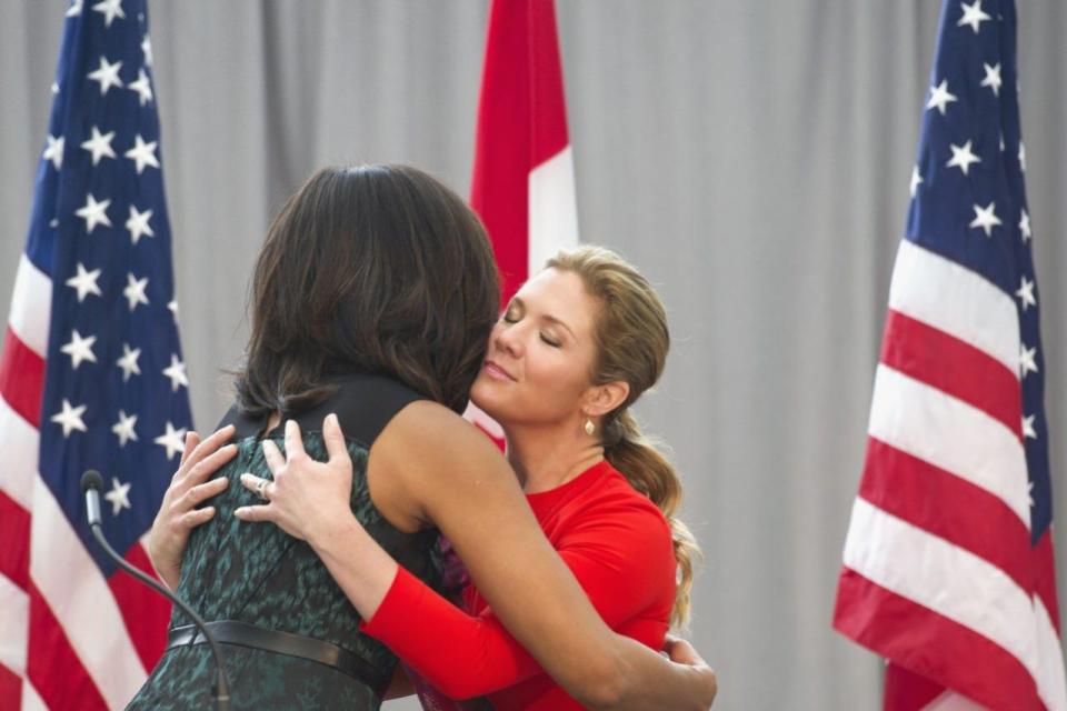 First lady Michelle Obama and Sophie Grégoire-Trudeau, wife of Prime Minister Justin Trudeau, hug while they participate in a program at the U.S. Institute of Peace in Washington, Thursday, March 10, 2016, to highlight Let Girls Learn efforts and raise awareness for global girl’s education. (AP Photo/Cliff Owen)
