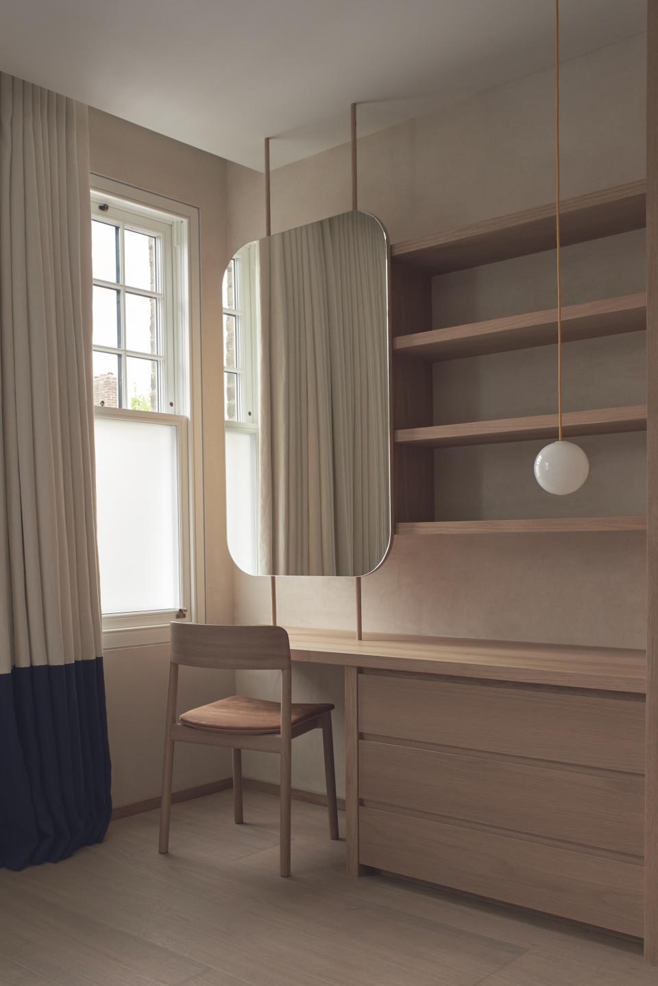 A dressing table area with frosted glass window pane