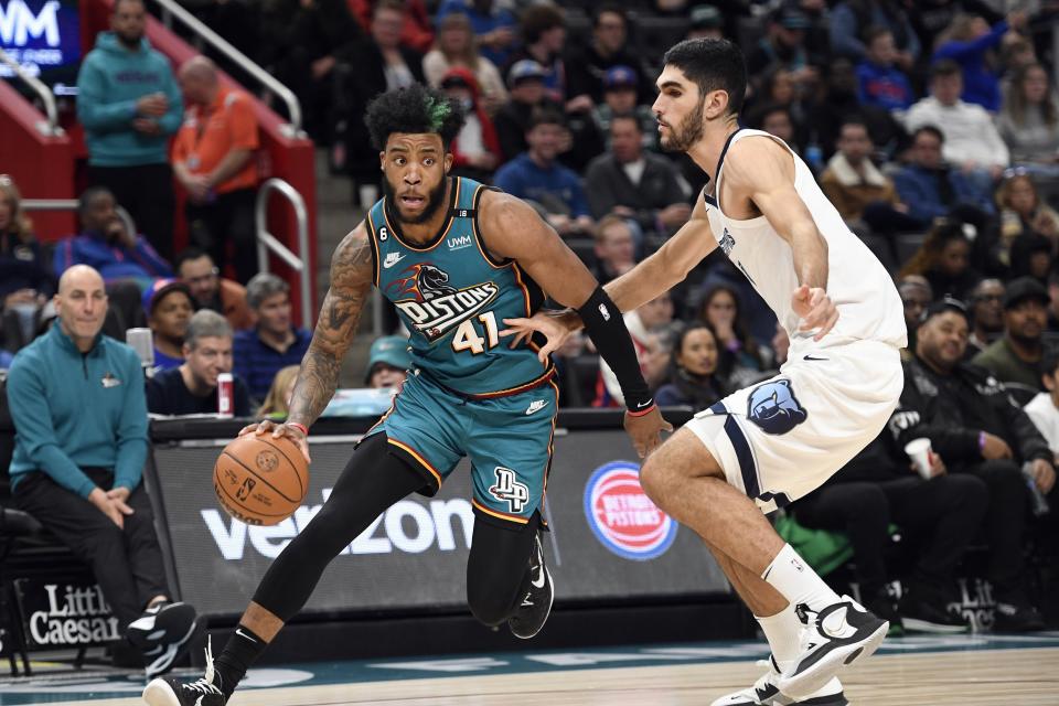 Detroit Pistons forward Saddiq Bey, left, tries to dribble past Memphis Grizzlies forward Santi Aldama during the second half of an NBA basketball game, Sunday, Dec. 4, 2022, in Detroit.