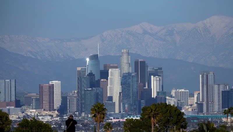 A visitor takes in a view of the city's skyline Thursday, March 2, 2023, in Los Angeles. Los Angeles is ranked by WalletHub as the best place to enjoy college basketball action.