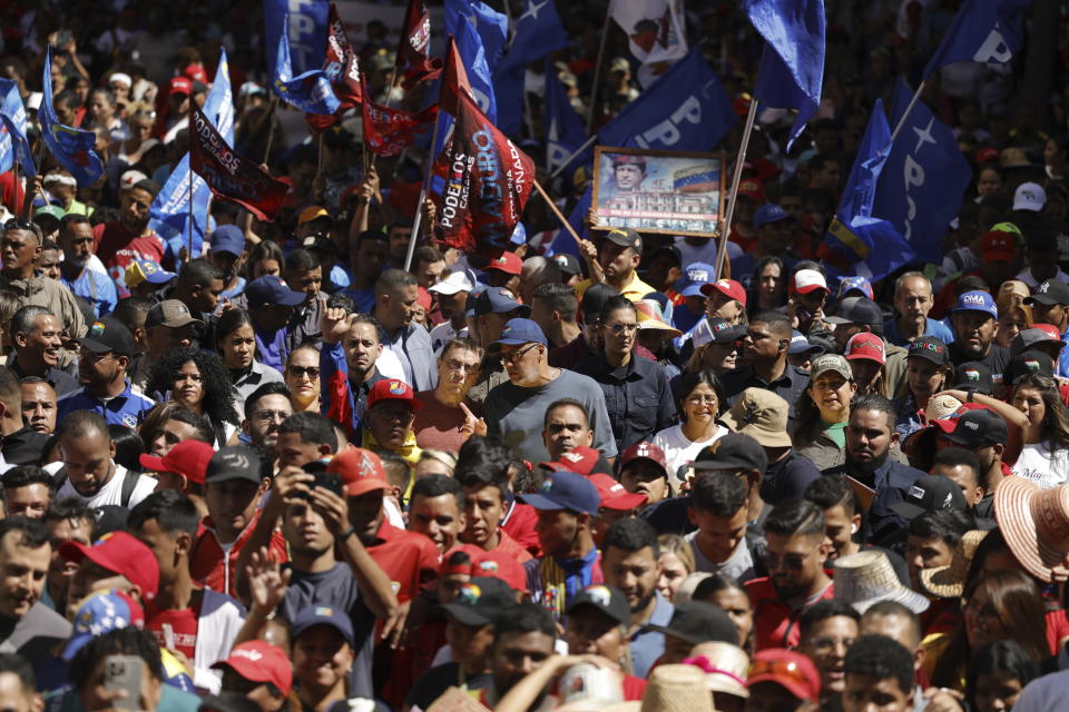 Government supporters march to mark the anniversary of the 1958 coup that overthrew dictator Marcos Perez Jimenez in Caracas, Venezuela, Tuesday, Jan. 23, 2024. At center is Congress President Jorge Rodriguez. (AP Photo/Jesus Vargas)