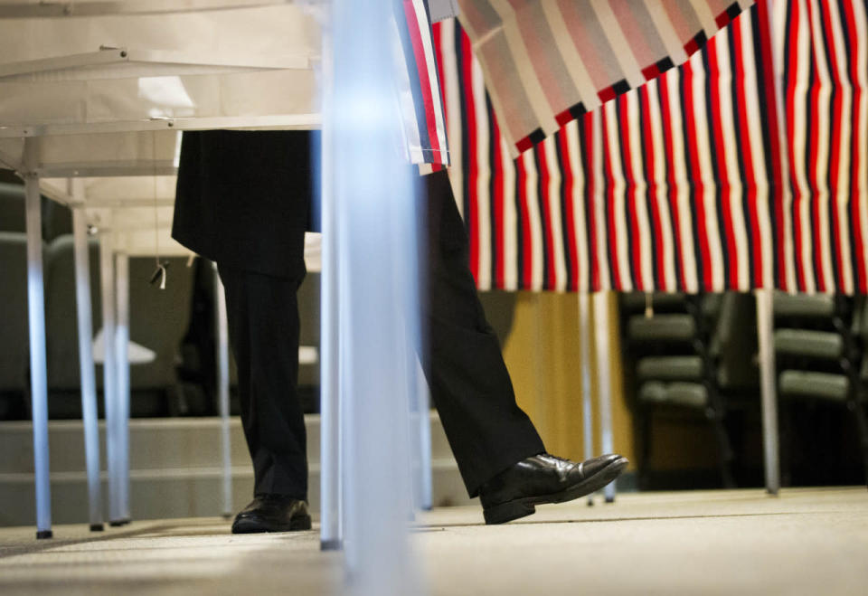 A voter steps out of a voting booth in Nashua