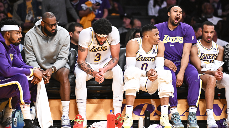 The LA Lakers players look dejected on the bench.