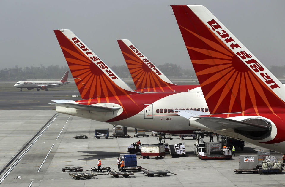 FILE - Air India aircrafts stand at Indira Gandhi International Airport in New Delhi, India, April 29, 2011. An Air India plane flying from New Delhi to San Francisco landed in Russia after it developed an engine problem, officials said on Wednesday, June 7, 2023. The plane, carrying 216 passengers and 16 crew members, landed safely at Russia’s Magadan airport in the country’s far east on Tuesday, Air India said in a statement. (AP Photo/Kevin Frayer, File)