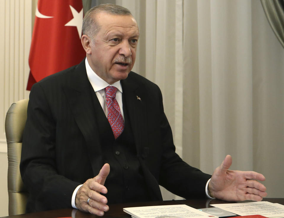 Turkey's President Recep Tayyip Erdogan speaks to the members of his ruling party in a televised address, in Ankara, Turkey, Wednesday, July 1, 2020. Erdogan vowed on Wednesday to tighten government control over social media, following alleged insults on Twitter to his daughter and son-in-law who announced the birth of their fourth child on the website. (Presidential Press Service via AP, Pool)