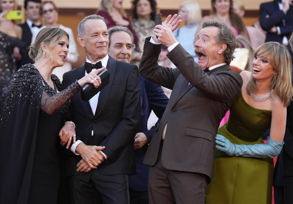 Rita Wilson, from left, Tom Hanks, composer Alexandre Desplat, Bryan Cranston and Maya Hawke pose for photographers upon arrival at the premiere of the film 'Asteroid City' at the 76th international film festival, Cannes, southern France, Tuesday, May 23, 2023. (Photo by Scott Garfitt/Invision/AP)