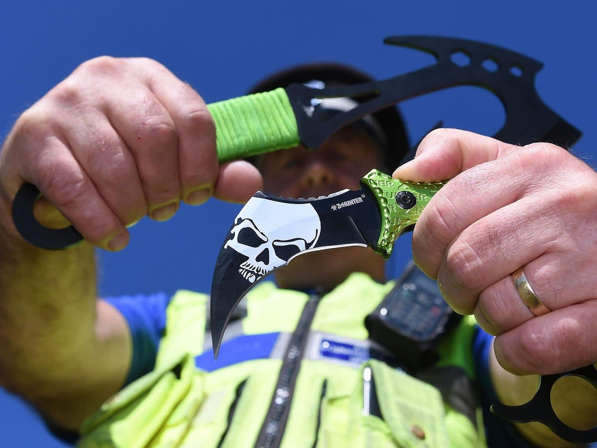 West Midlands PCSO Rob Capella holds two examples of zombie knives at a secure police location in Birmingham (PA)