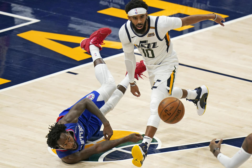 Los Angeles Clippers guard Patrick Beverley, left, and Utah Jazz guard Mike Conley (10) vie for a loose ball during the second half of an NBA basketball game Friday, Jan. 1, 2021, in Salt Lake City. (AP Photo/Rick Bowmer)