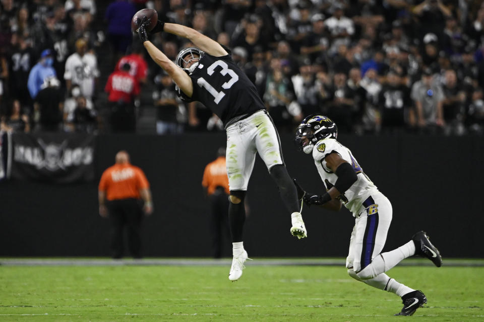 Las Vegas Raiders wide receiver Hunter Renfrow (13) makes a catch over Baltimore Ravens cornerback Marlon Humphrey (44) during the second half of an NFL football game, Monday, Sept. 13, 2021, in Las Vegas. (AP Photo/David Becker)