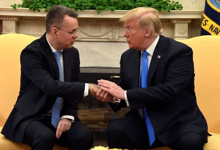 U.S. President Donald Trump welcomes Pastor Andrew Brunson, after his release from two years of Turkish detention, in the Oval Office of the White House, Washington, U.S., October 13, 2018. REUTERS/Mike Theiler