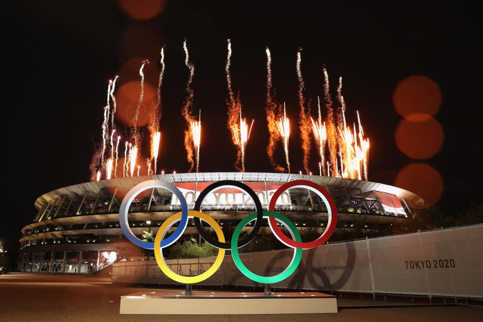 Olympic rings and fireworks outside of Tokyo Stadium.