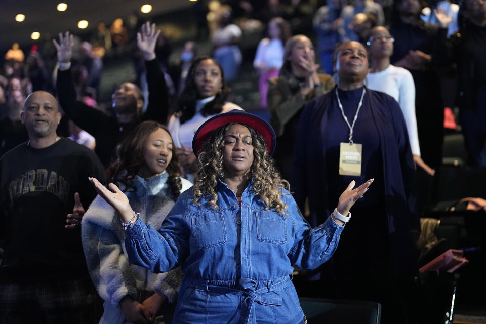The faithful sing during a service at Lakewood Church, Sunday, Feb. 18, 2024, in Houston. Pastor Joel Osteen welcomed worshippers back to Lakewood Church Sunday for the first time since a woman with an AR-style opened fire in between services at his Texas megachurch last Sunday. (AP Photo/David J. Phillip)