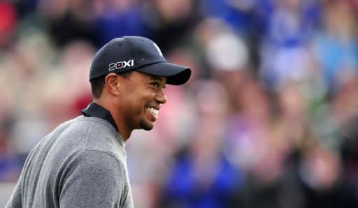 Tiger Woods of the US reacts after holing his shot from a green-side bunker on the 18th hole during his second round of the 2012 British Open Golf Championship at Royal Lytham and St Annes in England