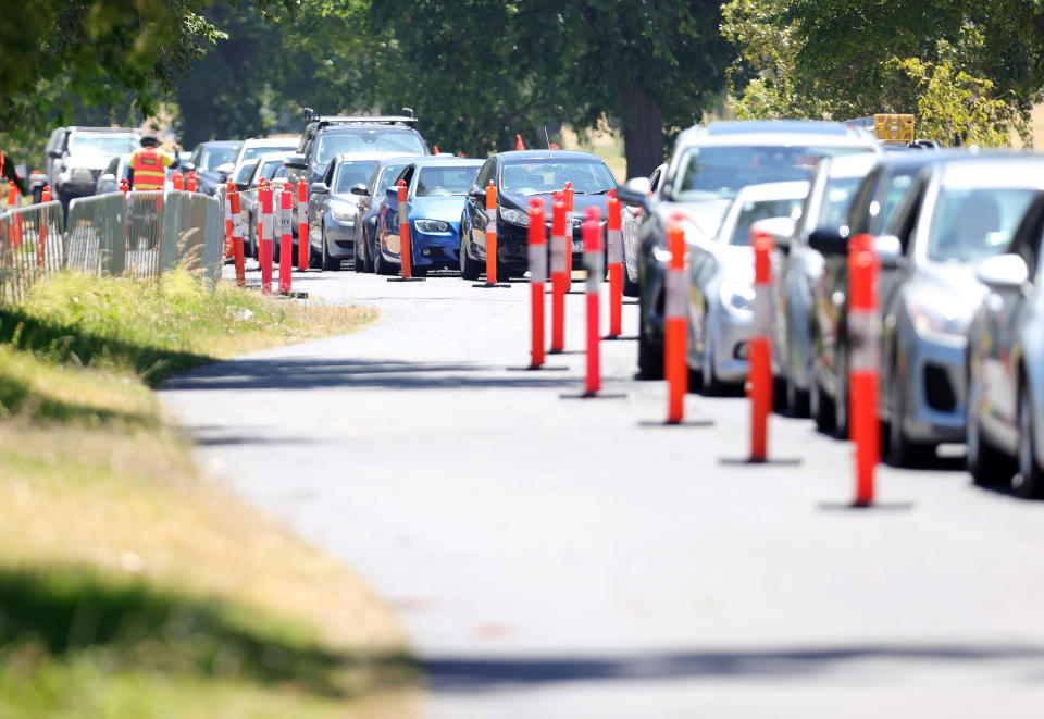 Members of the public are seen queuing in their cars at a drive-through Covid-19 testing site at Albert Park, in Melbourne on Thursday, December 30. Source: AAP