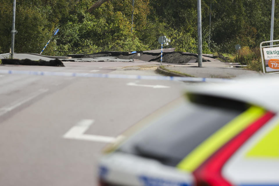 A view of the E6 near Stenungsund, closed in both directions after persistent rain caused a landslide, in Stenungsund, Saturday, Sept. 23, 2023. Three people have been injured and several buildings and vehicles damaged after a highway collapsed following a landslide in western Sweden early Saturday.Photos and video footage showed a huge sinkhole that had opened on the E6 highway, which runs from southern Sweden to Norway, not far from Sweden’s second largest city of Goteborg. (Adam Ihse/TT News Agency via AP)