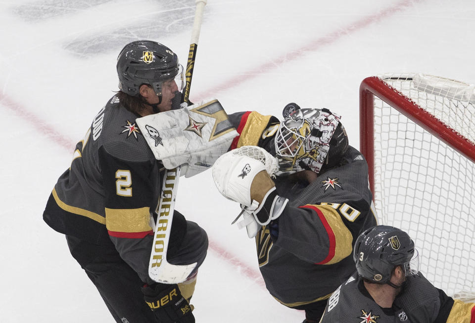 Vegas Golden Knights goalie Robin Lehner (90) makes a save as Zach Whitecloud (2) defends during the third period against the Chicago Blackhawks in Game 1 of an NHL hockey Stanley Cup first-round playoff series, Tuesday, Aug. 11, 2020, in Edmonton, Alberta. (Jason Franson/The Canadian Press via AP)