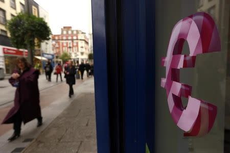 A sign displaying the Euro symbol is seen on a shop window in Dublin city centre October 22, 2014. REUTERS/Cathal McNaughton