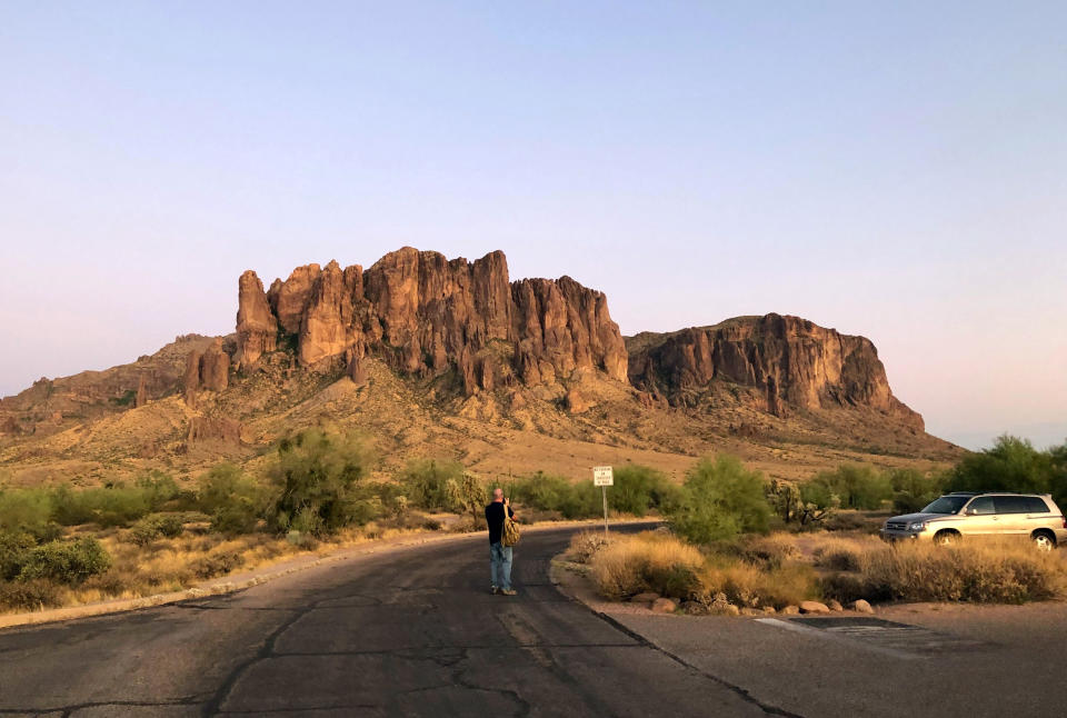 This Aug. 18, 2019 photo shows the Praying Hands Formation of the Superstition Mountains in Lost Dutchman State Park located outside of Phoenix, Ariz., where tourists can learn about and catch scorpions. (AP Photo/Peter Prengaman)