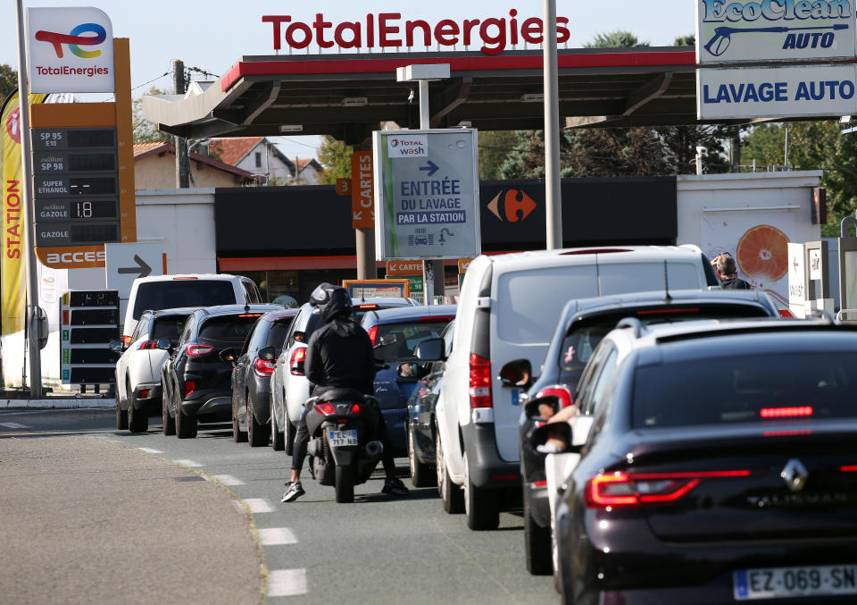 Drivers wait to fill their gas tank in a station in Anglet, southwestern France, Tuesday, Oct. 18, 2022. France is in the grip of transport strikes and protests for salary raise on Tuesday that threaten to dovetail with days of wage strikes that have already hobbled fuel refineries and depots, sparking chronic gasoline shortages around the country. (AP Photo/Bob Edme)