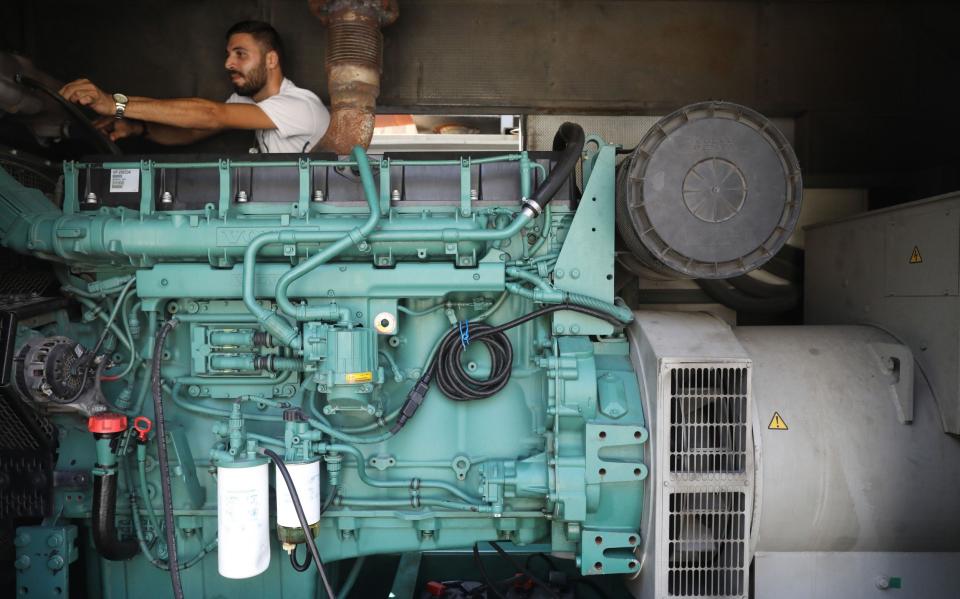 A man operates a generator in Beirut - Getty