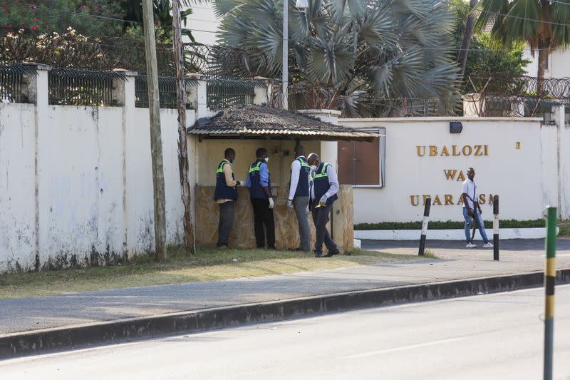 Tanzanian security officers guard an entrance to the French embassy after an attacker wielding an assault rifle was killed in the Salenda area of Dar es Salaam