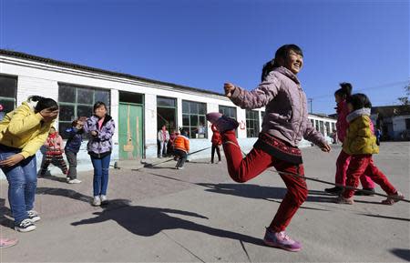 Students play a rope-skipping game during a break at Pengying School on the outskirts of Beijing November 11, 2013. REUTERS/Jason Lee