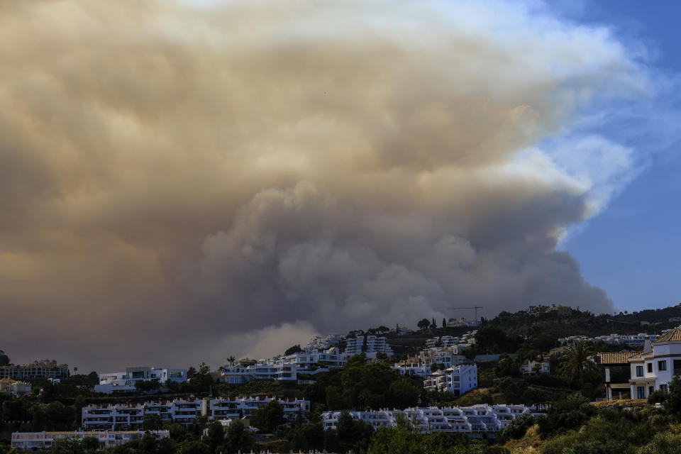 A wildfire advances near a housing urbanization in Marbella, Malaga, on Thursday, June 9, 2022. Emergency services deployed almost 1,000 firefighters, military personnel and support crews Thursday to fight a wildfire that has forced the evacuation of some 2,000 people in southern Spain amid fears that torrid weather may feed the blaze. (AP Photo/Gregorio Marrero)