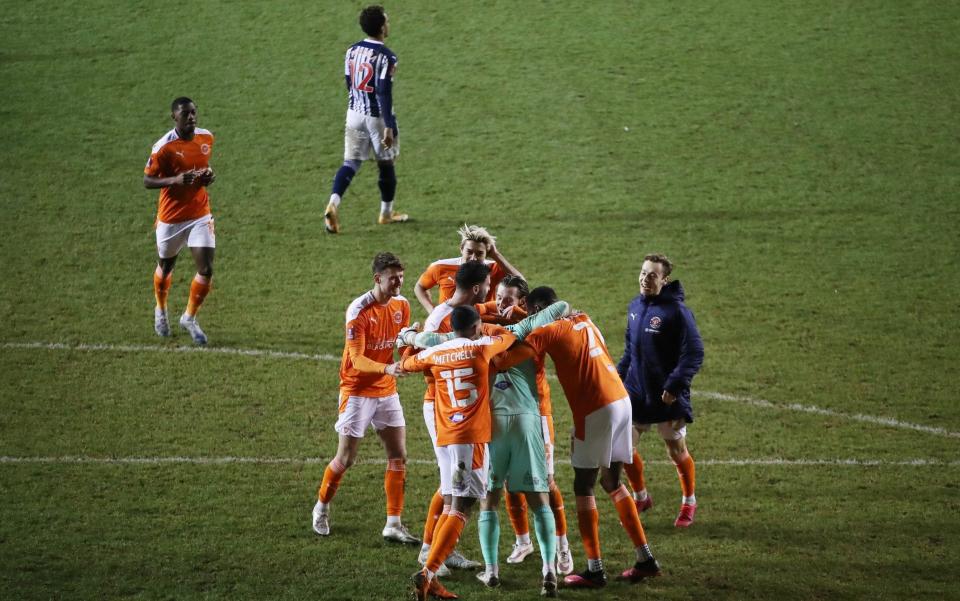 Blackpool players celebrate after winning the penalty shootout  - REUTERS