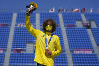 Gold medal winner Keegan Palmer of Australia poses for photos after the men's park skateboarding finals at the 2020 Summer Olympics, Thursday, Aug. 5, 2021, in Tokyo, Japan. (AP Photo/Ben Curtis)