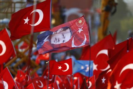 A flag with the picture of Turkey's President Tayyip Erdogan is seen during the Democracy and Martyrs Rally, organized by him and supported by ruling AK Party (AKP), oppositions Republican People's Party (CHP) and Nationalist Movement Party (MHP), to protest against last month's failed military coup attempt, in Istanbul, Turkey, August 7, 2016. REUTERS/Osman Orsal