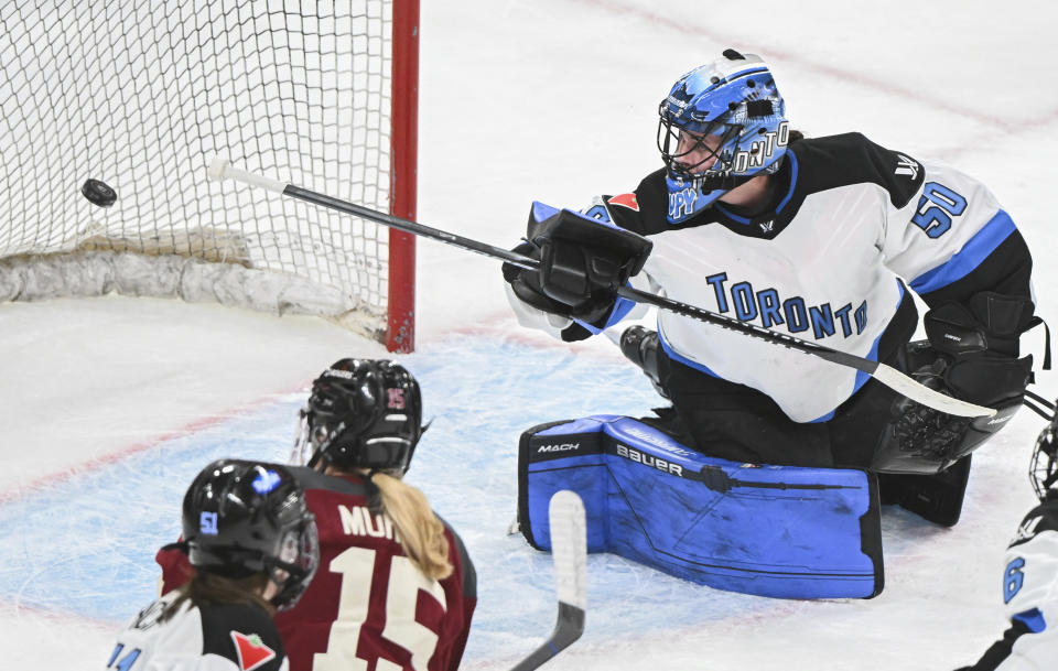 Toronto goaltender Kristen Campbell is scored on by Montreal's Sarah Bujold, not shown, during the first period of a PWHL hockey game at the Bell Centre in Montreal, Saturday, April 20, 2024.(Graham Hughes/The Canadian Press via AP)