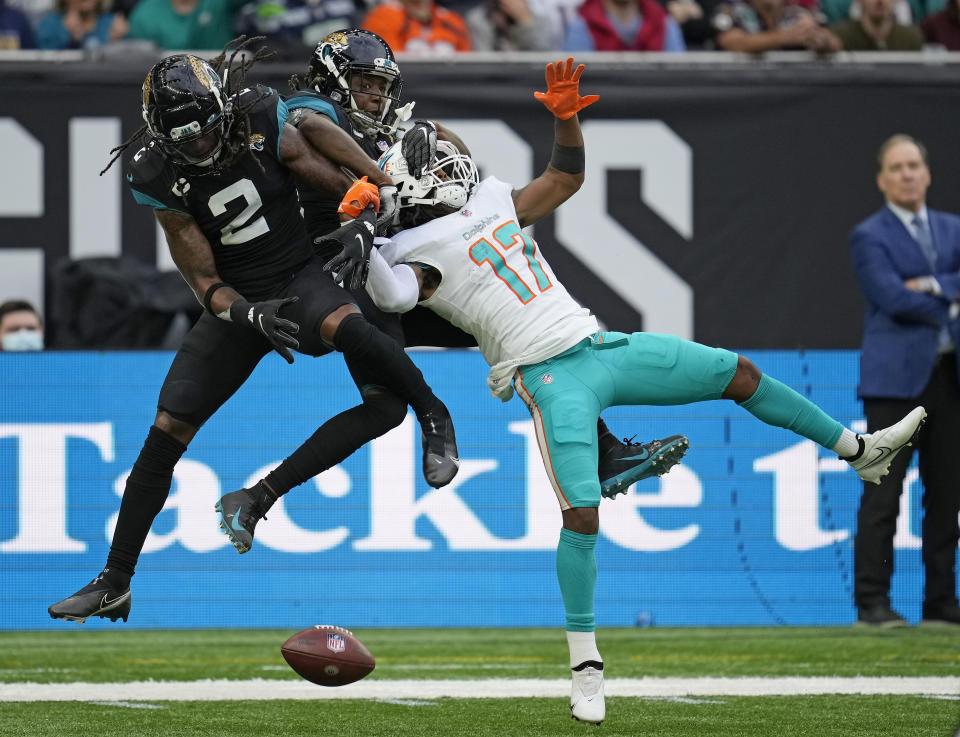 Miami Dolphins wide receiver Jaylen Waddle (17) is challenged by Jacksonville Jaguars free safety Rayshawn Jenkins (2) during the second half of an NFL football game between the Miami Dolphins and the Jacksonville Jaguars at the Tottenham Hotspur stadium in London, England, Sunday, Oct. 17, 2021. (AP Photo/Matt Dunham)