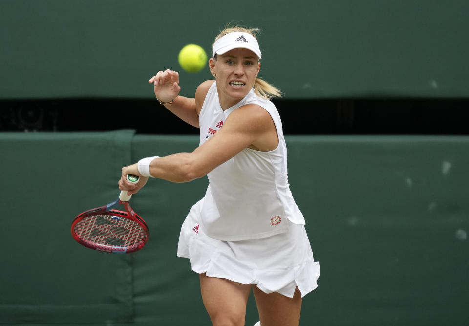 Germany's Angelique Kerber plays a return to Australia's Ashleigh Barty during the women's singles semifinals match on day ten of the Wimbledon Tennis Championships in London, Thursday, July 8, 2021. (AP Photo/Alberto Pezzali)