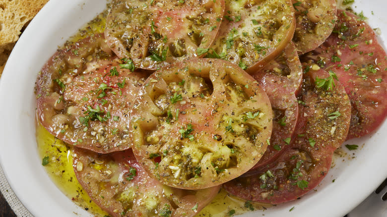 plate of brandywine tomatoes with olive oil