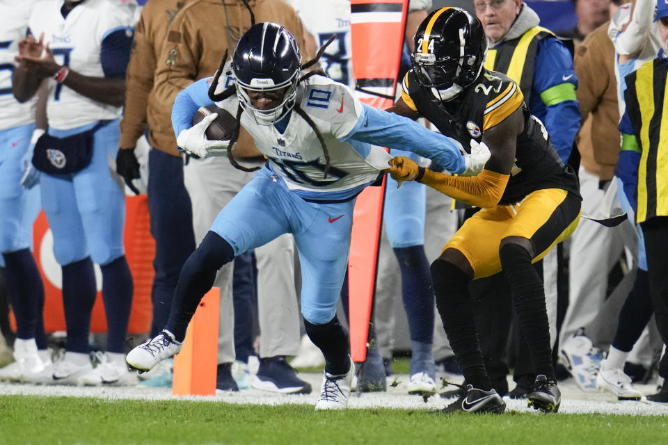 Tennessee Titans wide receiver DeAndre Hopkins (10) makes a catch past Pittsburgh Steelers cornerback Joey Porter Jr. (24) during the first half of an NFL football game Thursday, Nov. 2, 2023, in Pittsburgh. (AP Photo/Gene J. Puskar)