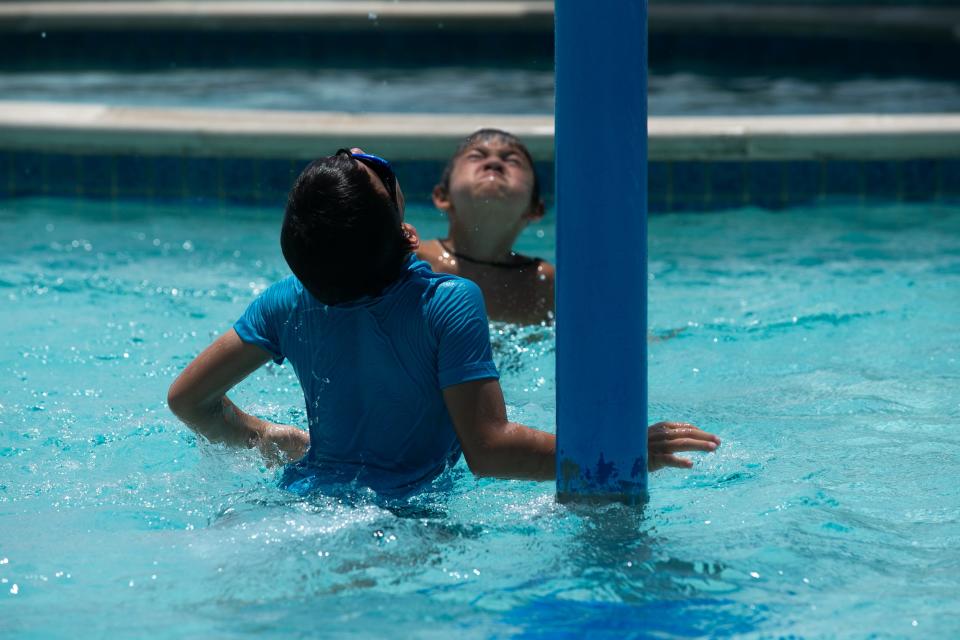 From left, Nate Martinez, 7, and Colton Stoner, 7, wait to be doused in water from an overhead bucket at Corpus Christi's H-E-B Pool Friday, July 7, 2023.