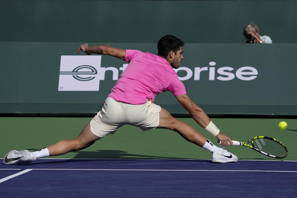 Carlos Alcaraz, of Spain, returns a shot against Jannik Sinner, of Italy, during a semifinal match at the BNP Paribas Open tennis tournament Saturday, March 18, 2023, in Indian Wells, Calif. (AP Photo/Mark J. Terrill)