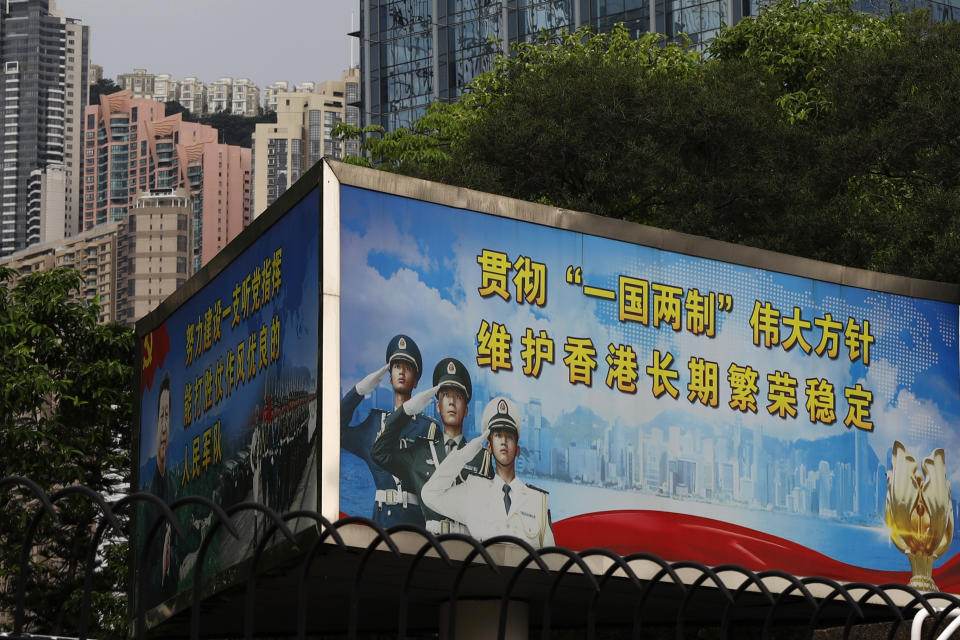 The billboard which reads "Implement the great policy of 'One Country, Two Systems', maintain Hong Kong's long term prosperity and stability", is displayed at the People's Liberation Army (PLA) central barracks in Hong Kong, Friday, May 22, 2020. Hong Kong's pro-democracy lawmakers have sharply criticized China's move to take over long-stalled efforts to enact national security legislation in the semi-autonomous territory. They say it goes against the "one country, two systems" framework that promises the city freedoms not found on the mainland. (AP Photo/Kin Cheung)