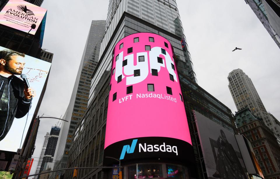 The Lyft logo is shown on the screen at the Nasdaq offices in Times Square on March 29, 2019 in New York. Nasdaq: LYFT, the multimodal transportation network, - Ride-hailing company Lyft made  its Initial Public Offering (IPO) on the Nasdaq Stock Market on March 29. (Photo by Don Emmert / AFP)        (Photo credit should read DON EMMERT/AFP/Getty Images)